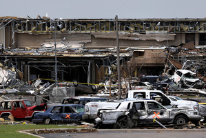 Destroyed vehicles and other tornado debris pile up in front of the Moore Medical Centre. Photo / AP