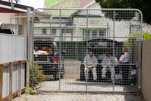 Police at the house where a woman was badly burned on Christmas Day and later died. Photo / File / Glenn Taylor