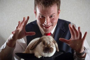 Now you see him... Magician Mick Peck and friend. Photo / APN