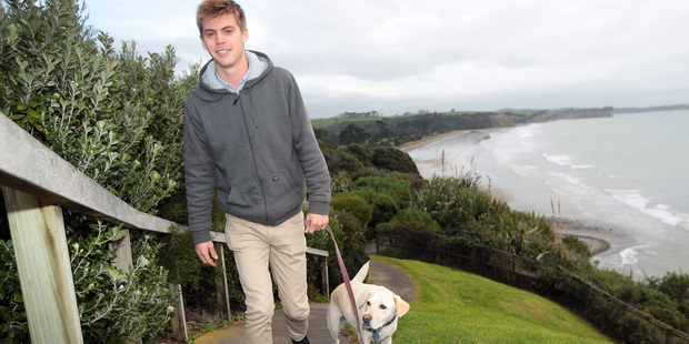 Ben Sanders with dog Wanda at their Happy Place walking on the cliffs between Long Bay and Torbay. Photo / Doug Sherring