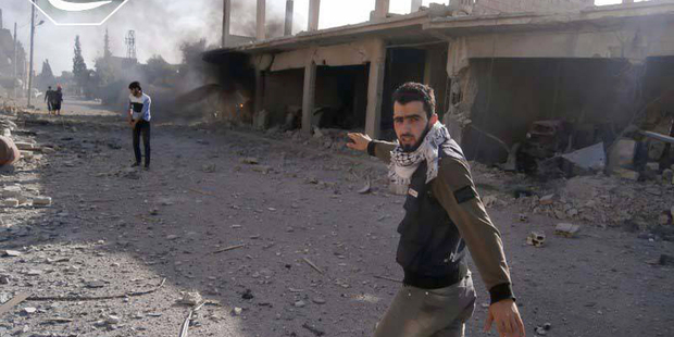 Activist Hadi Abdullah on a street in Qusair devastated by the shelling of Syrian government forces backed by Lebanese Hizbollah fighters. Photo / AP