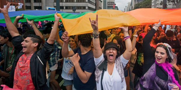 Participants hold a rainbow flag as they march during the annual Gay Pride Parade in Sao Paulo, Brazil. Photo / AP