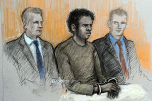 Court sketch of Michael Adebowale, flanked by two police officers in the dock, during his appearance at Westminster Magistrates. Image / Elizabeth Cook / AP