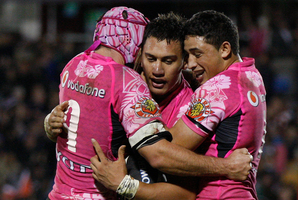 Nathan Friend (left) and Kevin Locke (right) celebrate a try by Elijah Taylor (centre). Photo / Richard Robinson