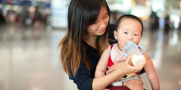 A mother feeds her baby at shopping mall in Beijing. Booming demand for NZ infant formula means inexperienced companies are trying to cash in - putting our reputation at risk, says the industry's big players. Photo / David White.