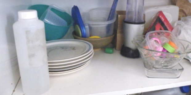 Bottle containing acetone (used in the manufacture of P) in close proximity to container used to store lids and teats from baby bottles. Photo / Supplied