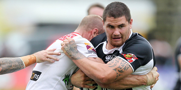 Warrior's Russell Packer is tackled by Dragons Matt Coope. Photo / APN
