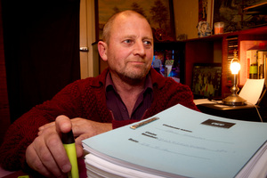 Paul Shann pictured at home in Puketapu with a large amount of ACC paperwork. Photo / Glenn Taylor