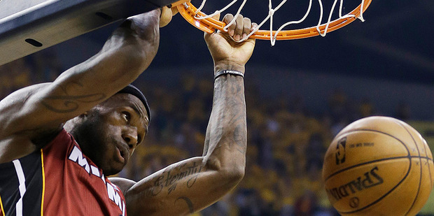 LeBron James of the Miami Heat dunks against the Indiana Pacers. Photo/AP