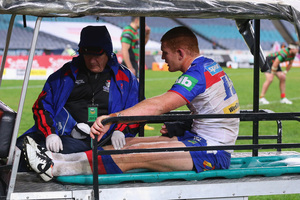 Newcastle's Alex McKinnon is taken from the field after being injured in an alleged 'cannonball' tackle. Photo / Getty Images