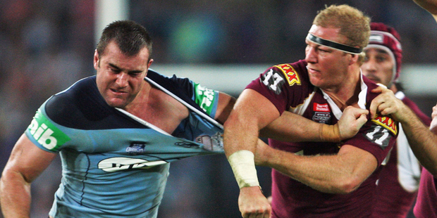 Justin Poore of the Blues and Michael Crocker of the Maroons throw punches during game two of the 2009 series. Photo / Getty Images