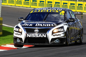 Rick Kelly not only has to concentrate on driving his Nissan V8 superbly, but he must talk to his pit crew as well. Photo / Supplied
