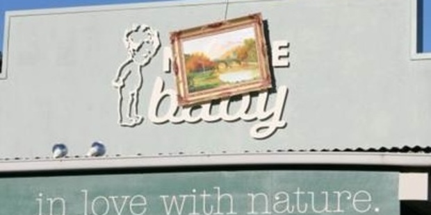Someone scaled the roof of Nature Baby in Grey Lynn and hung an English landscape across the signage. "Part art heist, part tagger, part poet and very Grey Lynn," says owner Jacob Faull.