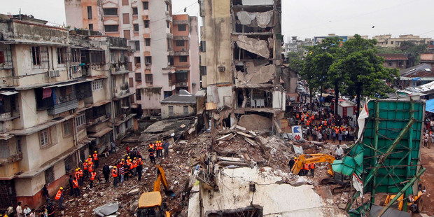 Rescue workers search for trapped people after a residential building collapsed in Mumbai, India. Photo / AP