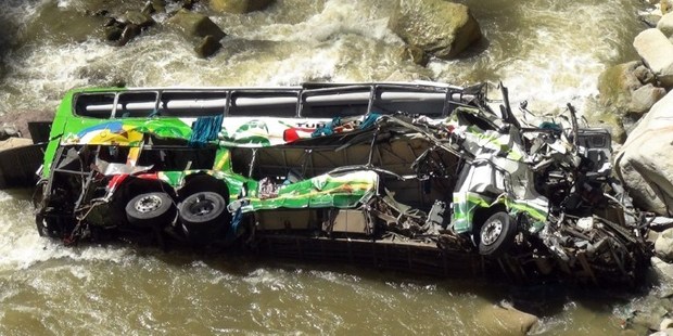 The wrecked remains of a passenger bus that plunged into a 50 meter deep ravine of the Tarma River, in Tarma, some 245 northeast of Lima, Peru. Photo / AFP