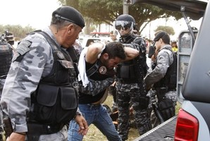 Riot police arrest a protester during a rally near Brasilia's Estadio Nacional Mane Garrincha to protest against the allocation of funds towards next year's World Cup. Photo / AP