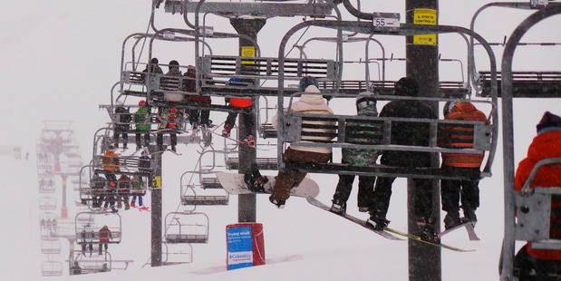 Skiers on the Remarkables skifield chairlift near Queenstown.