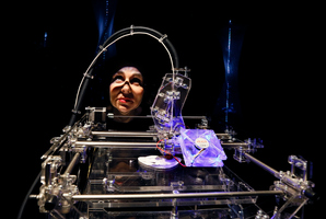 Designer Susana Soares looks through a 3D printer that makes biscuits from flour made from insects at the Wellcome Collection in London. Photo / AP