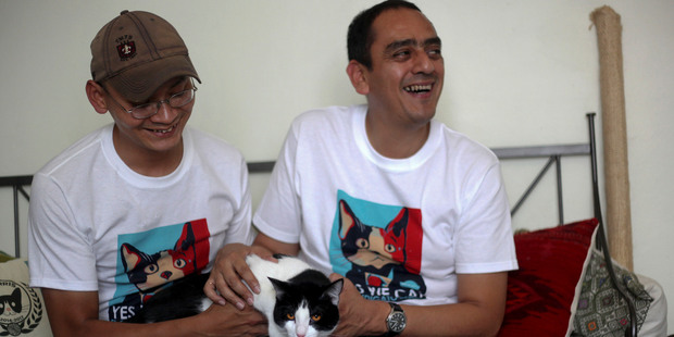 Sergio Chamorro, right, and friends put up Morris the cat as a candidate after they became disillusioned by politicians' empty promises. Photo / AP