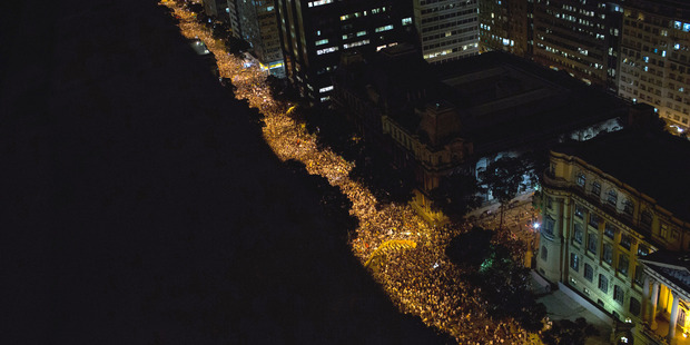 Acts of vandalism marred generally peaceful protests with about 100,000 taking to the streets in Rio de Janeiro. Photo / AP