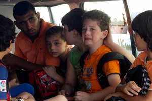 An ambulance takes children away from clashes in Sidon, Lebanon, in the latest apparent outbreak of violence between Lebanese factions supporting opposing sides in the civil war in neighboring Syria. Photo / AP