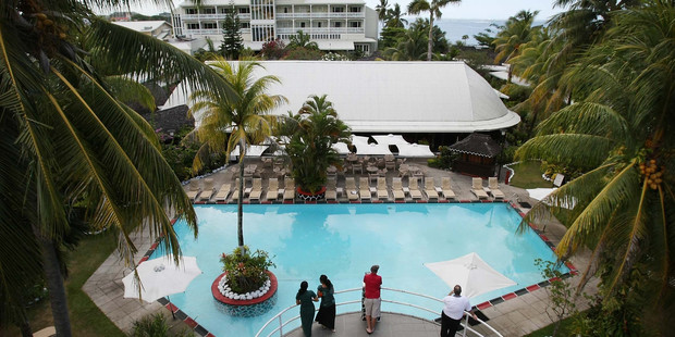 Guests around the pool, pre-Cyclone Evan, at Aggie Grey's in Apia. Photo / Greg Bowker