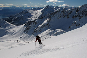 A skier makes his way down an untracked face in The Remarkables range. Photo / Sarah Ivey