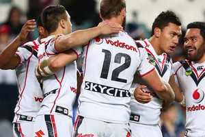 Elijah Taylor of the Warriors is congratulated by his team after scoring a try during the round 14 NRL match between the Sydney Roosters and the New Zealand Warriors. Photo / Getty Images.
