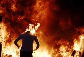 A mannequin burns outside a room that was lit on fire for a burn test demonstration at the Bureau of Alcohol, Tobacco, and Firearms National Laboratory Center in Maryland, US. Photo / AFP