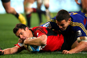 Dan Carter of the Crusaders scores a try in the tackle of Tamati Ellison of the Highlanders during the round 18 Super Rugby match between the Highlanders and the Crusaders. Photo / Getty Images.