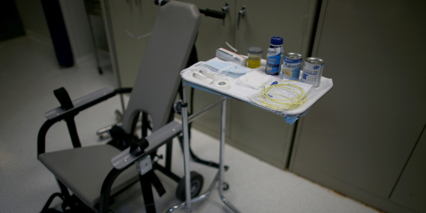 Hunger-striking inmates are strapped into the restraint chair and force-fed through a tube while being asked to indicate their pain level on a chart. Photo / Getty Images