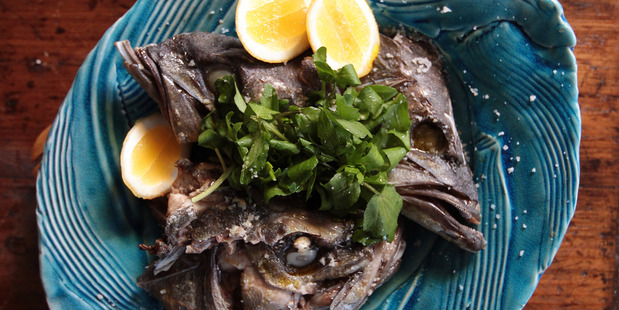 Slow roasted fish heads. Photo / Doug Sherring