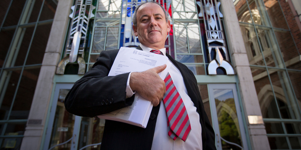 Lawyer Andrew Hooker outside the High Court in Auckland with the statement of claim that he today filed against the ANZ Bank. Photo / Greg Bowker