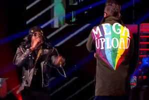 Dizzee Rascal (left) and Robbie Williams get the megaupload name in front of the crowd.