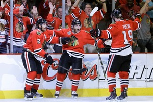 Chicago defenceman Patrick Kane, centre, scored two of the Blackhawks' goals in game five against the Boston Bruins. Photo / AP