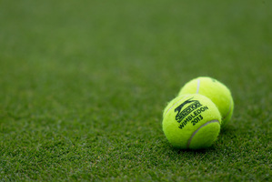 Tennis balls emblazoned with Wimbledon 2013 - and featuring NZ wool - are placed on a court during a match. Photo / AP
