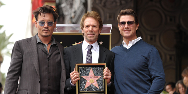 Johnny Depp, from left, Jerry Bruckheimer, and Tom Cruise appear at a ceremony honouring Bruckheimer with a star on the Hollywood Walk of Fame in Los Angeles. Photo / AP