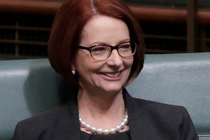 Former Australian Prime Minister Julia Gillard smiles after arriving in chambers at parliament today. Photo / AP