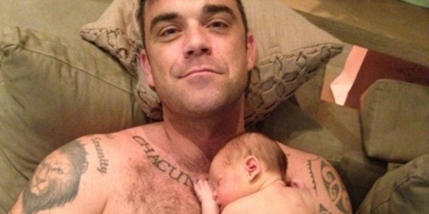 Robbie Williams poses with his newborn daughter Theodora Rose.