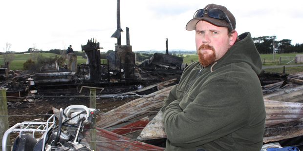 Dannevirke's Owen Reynolds at the scene of the fire which destroyed his family home. Photo / Christine McKay