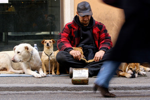 Cities have different methods of dealing with beggars. Photo / AP