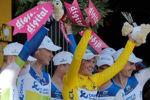 Stage winner team Orica Greenedge with Simon Gerrans of Australia, wearing the overall leader's yellow jersey, celebrates on the podium of the fourth stage of the Tour de France. Photo / AP