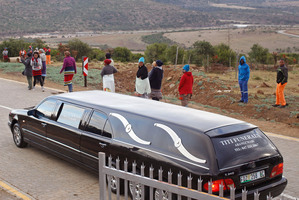 A hearse escorted by police arrives at the home of Mandla Mandela, the grandson of Nelson Mandela, to collect remains in Mvezo, South Africa. Photo / AP