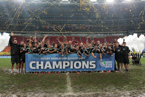The New Zealand men's and women's sevens sides with their trophies after winning the Rugby Sevens World Cups at Luzhniki stadium in Moscow. Photo / AP