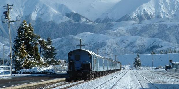 The TranzAlpine amid the grandeur of the Southern Alps at Springfield Station. Photo / Tranz Scenic