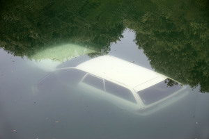 The sunken car after it crashed into the freezing water, trapping three people inside. Photo / Tim Cuff
