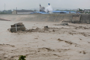 In this photo provided by China's Xinhua News Agency, a collapsed bridge over the Panjiang river is seen in Qinglian, Jiangyou city, southwest China's Sichuan Province. Photo / AP