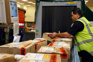 Packages coming in from overseas at the Auckland Mail Centre. Charging GST on goods bought overseas online would be 'virtually impossible' said Customs Minister Maurice Williamson. Photo / NZ Herald