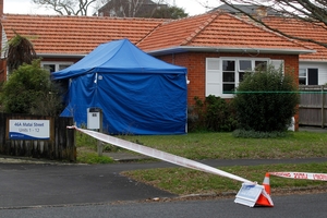 Police set up a cordon round the house after the body was found. Picture / Christine Cornege