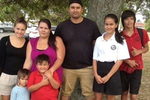 Jasmine McPhee, with husband Vance and children, once had to cook over a candle because her power had been cut off.